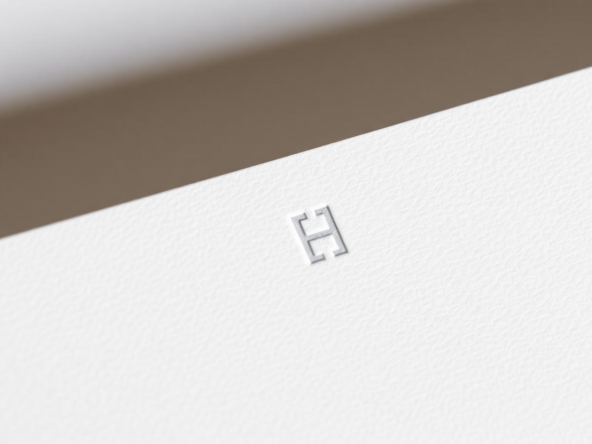 Close-up of textured paper stock with embossed logo